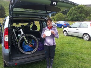Car with both bikes and rain cover, me with welly boots and silver plate!