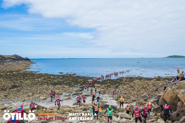Stream of racers getting in for the first swim