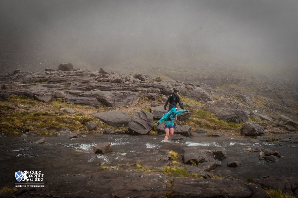 Dave and I crossing a river on the Cape Wrath Ultra - it's very grey and wet