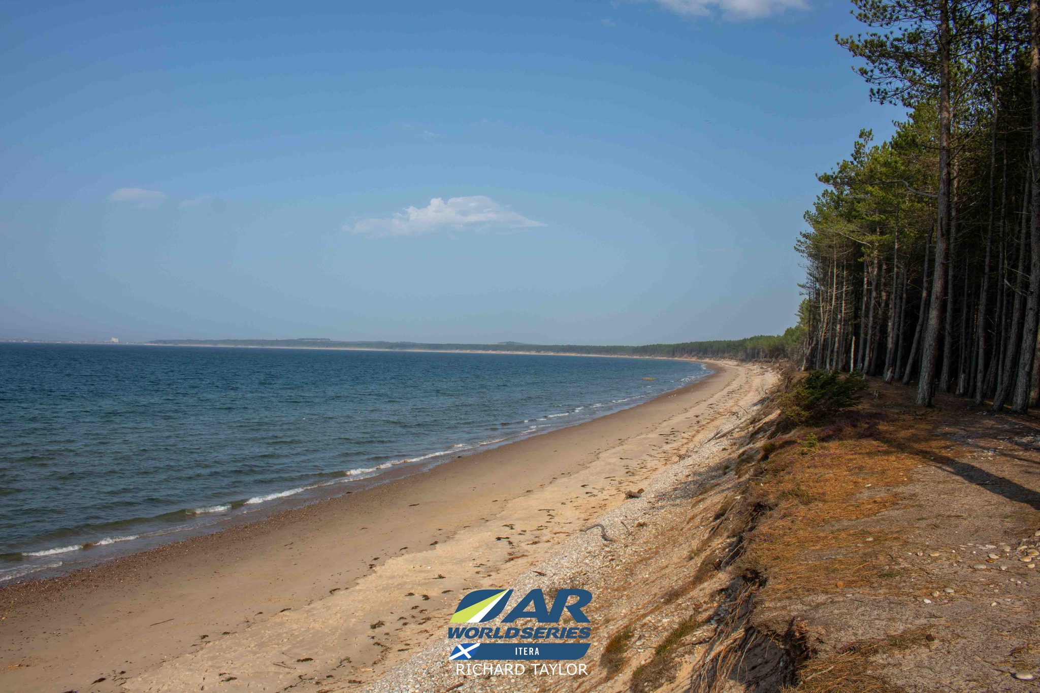 Long sweeping beach, with woodland all along the shoreline as far as the eye can see